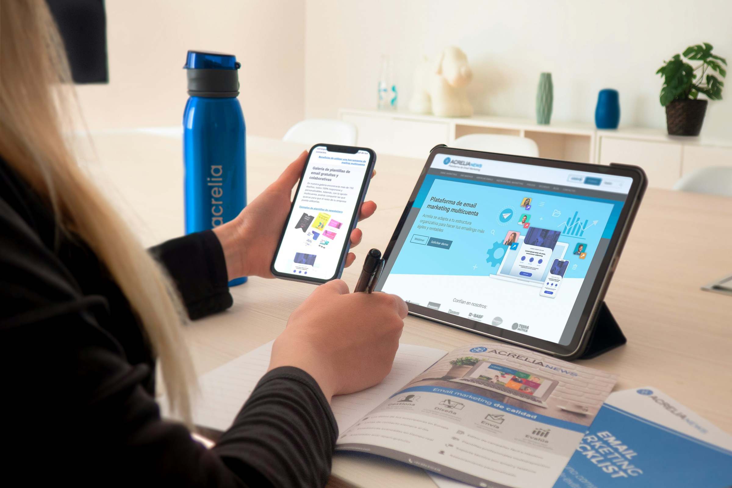 A woman working at a table with a tablet and phone, managing her site without a dashboard